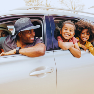 Family in car, ready to hit the road for a road trip
