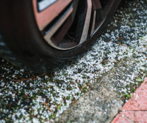 Car tire with hail on ground