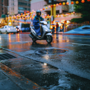 Seasonal shot of street with parked vehicles and a moped
