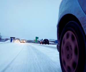 A shot from the tire of a vehicle of a snow-covered road