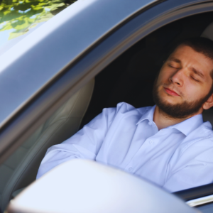 Man sleeping behind the wheel